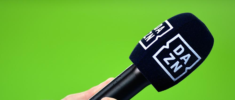 Die Hand eines Reporters hält bei einem Interview vor dem Spiel ein Mikrofon mit der Aufschrift Dazn.