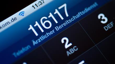 Die Telefonnummer 116117 des ärztlichen Bereitschaftsdienstes ist auf dem Display eines Smartphones am zu lesen.