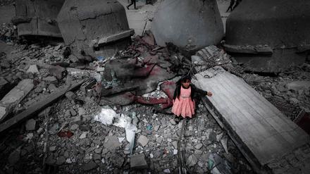Ein palästinensisches Mädchen in einem rosa Kleid steht inmitten der Ruinen der Al-Faruq-Moschee, die während der israelischen Bombardierung in Rafah Mitte März zerstört wurde.